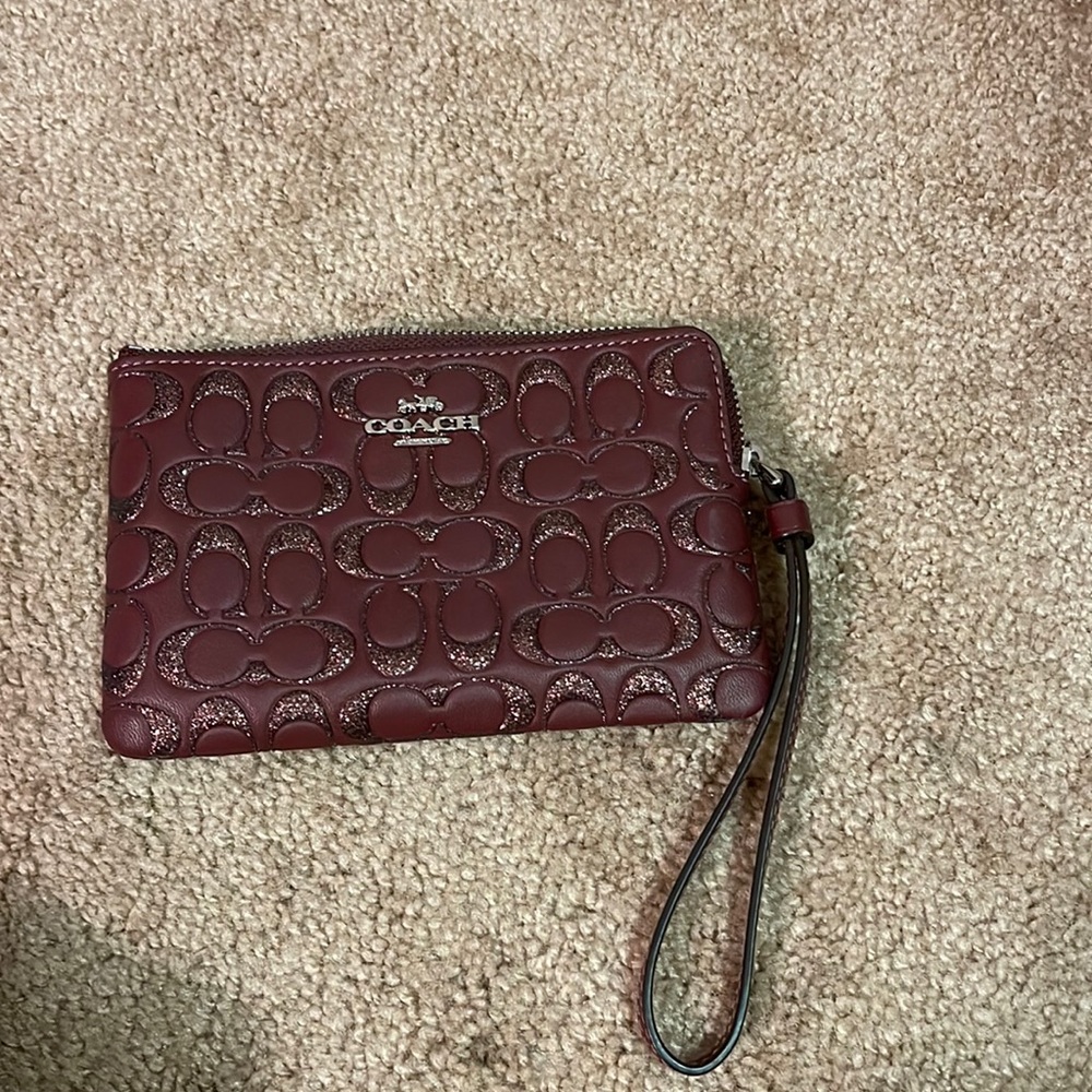 Burgundy coach wristlet with glitter logo